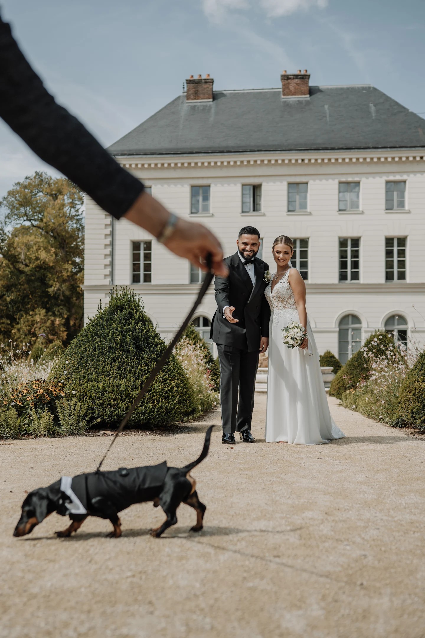 Veronica and Mohamed with their dog at a Normandy château wedding